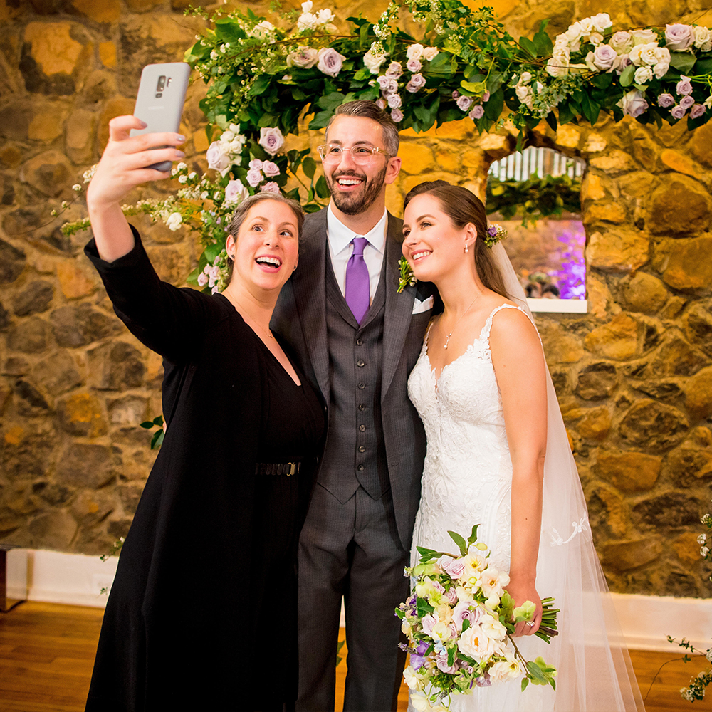 Rev. Lisa takes an officiant selfie with her couple